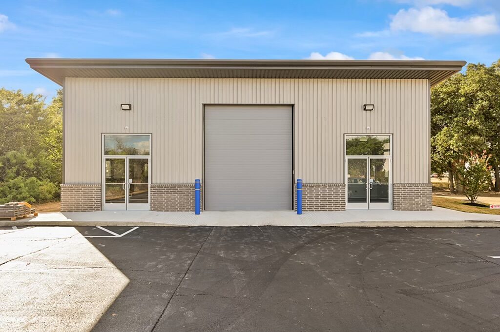 Office and warehouse metal building in College Station, Texas with a centered 14 foot overhead door and brick wainscot