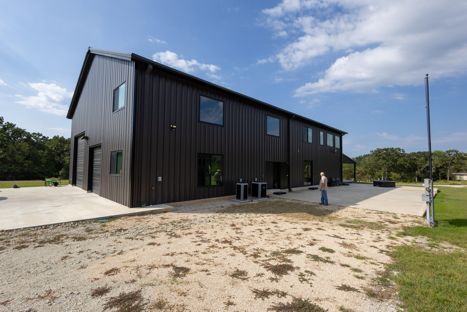 Rear elevation with condensing units and the walk door into the shop