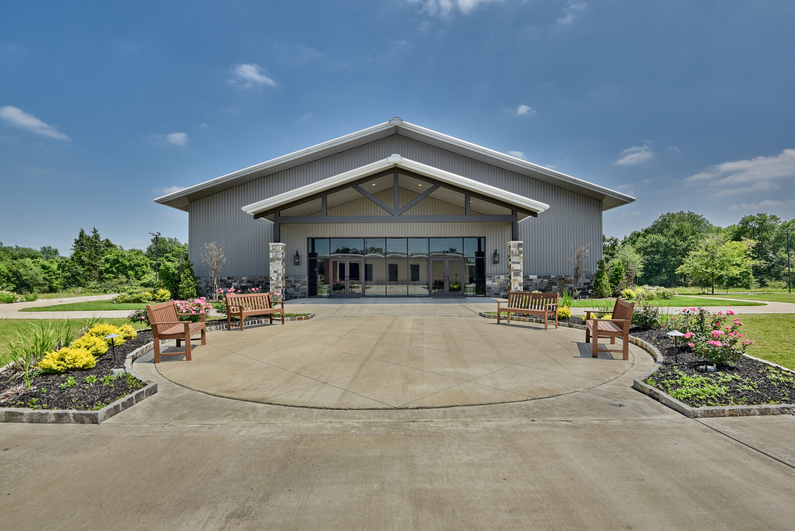 Emmanuel Baptist Church in Bryan, Texas: a 74 by 108 metal building sanctuary with a steel-truss entry, masonry base and a circular entry plaza