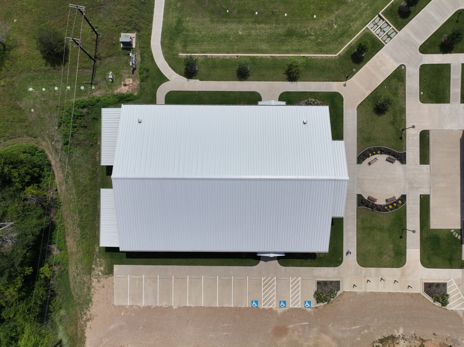 Overhead view of the church roof showing the standing-seam panels, the extensions and the entry plaza