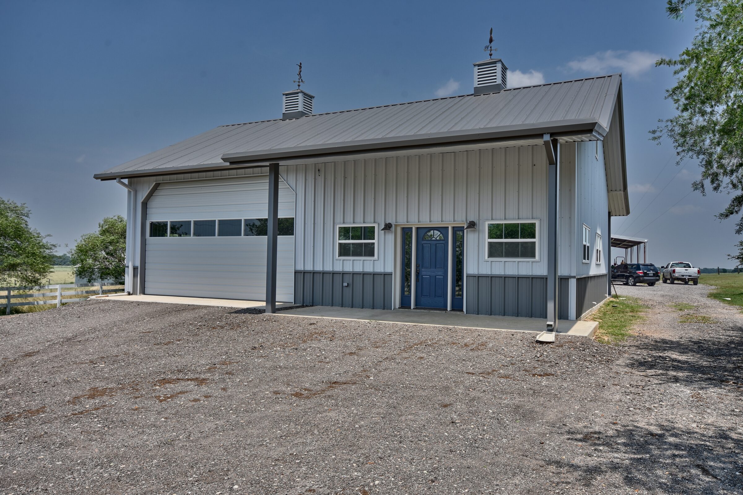 34 by 46 custom garage and game room in Snook, Texas, with a 6:12 main roof, low-pitch porch roofs and an oversized roll-up door