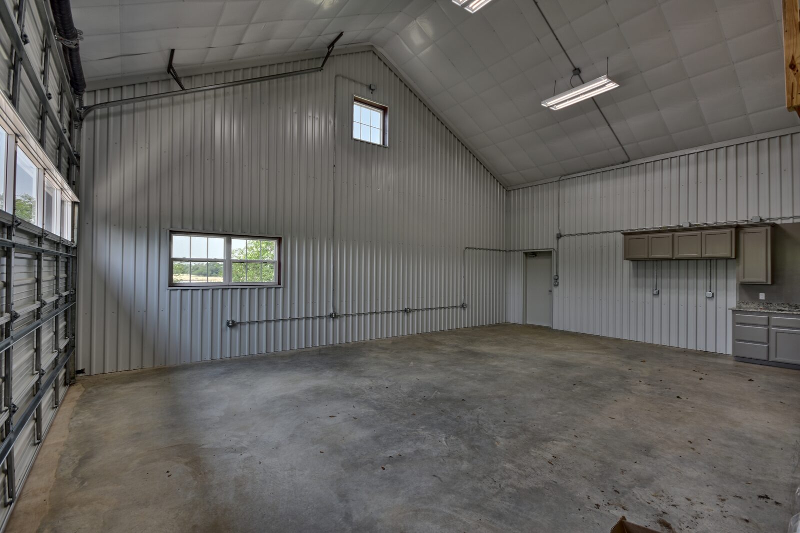 Shop interior finished with metal liner panel to the eave line, cabinets and a counter